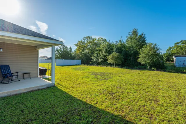 a view of a swimming pool with a table and chairs