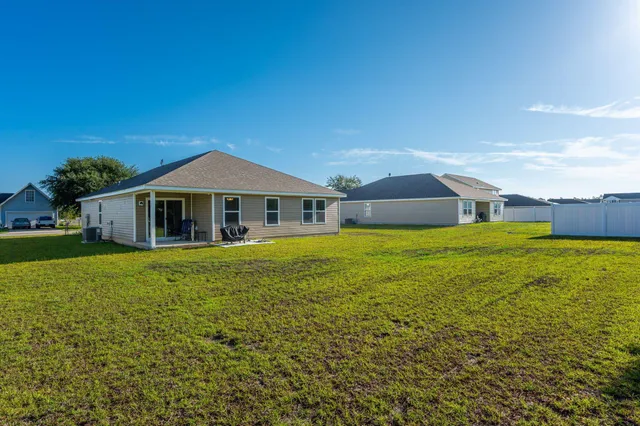 a front view of house with yard and swimming pool