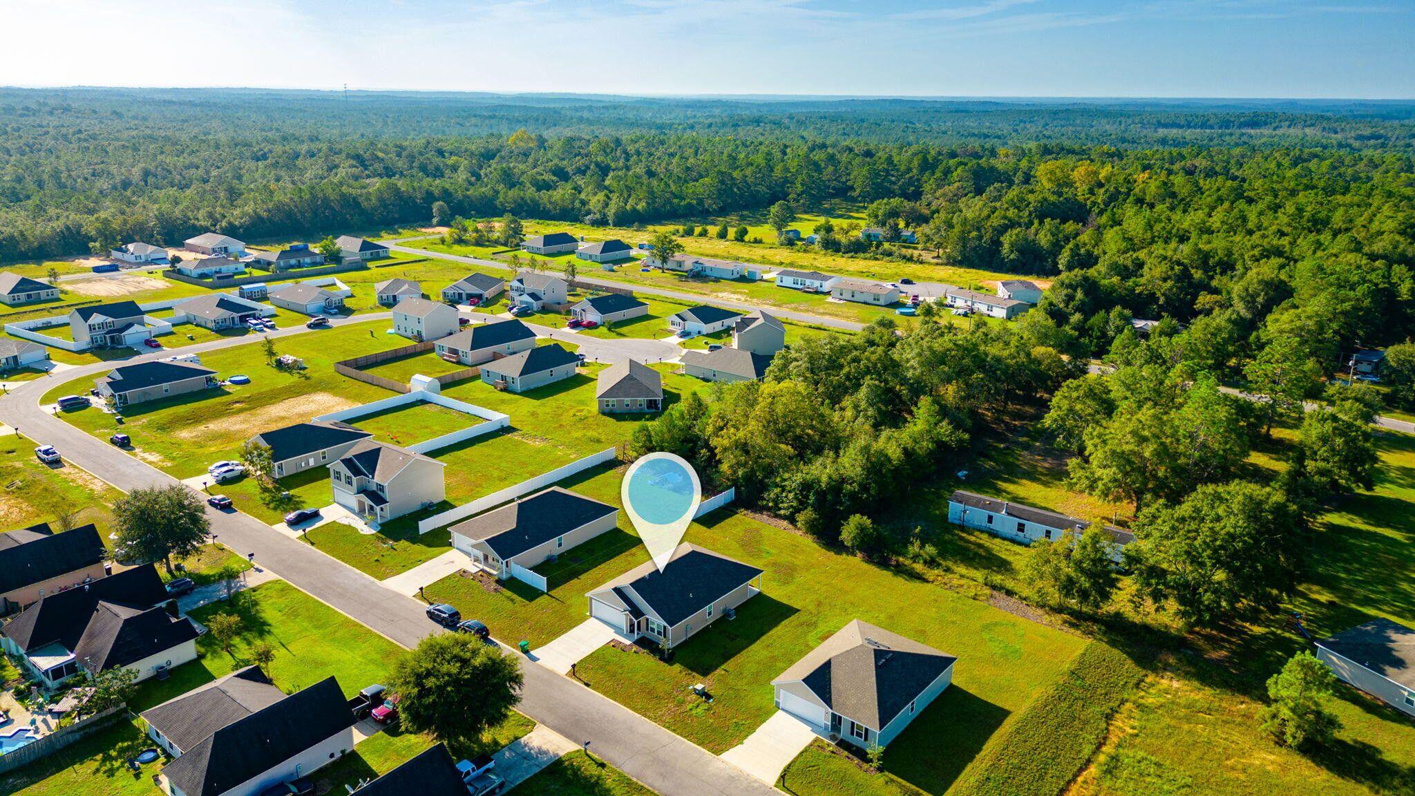 42 Lockwood Way East DeFuniak Springs, FL 32435 - Photo 36 of 39 a view of yard with swimming pool outdoor seating and trees