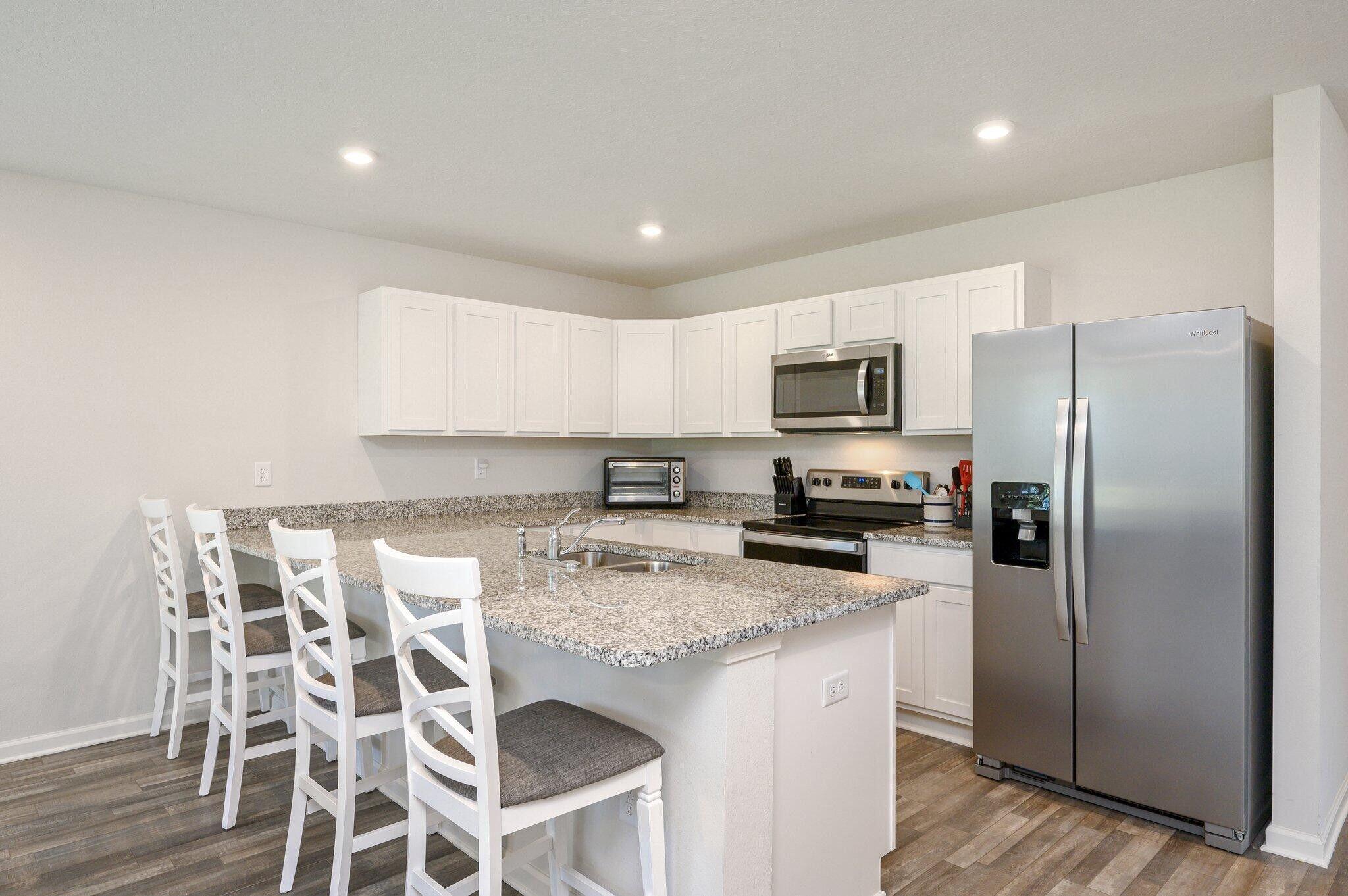 42 Lockwood Way East DeFuniak Springs, FL 32435 - Photo 5 of 39 a kitchen with granite countertop a refrigerator and microwave
