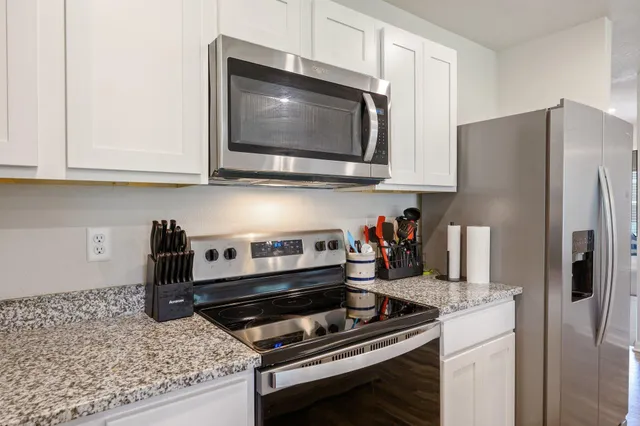 a kitchen with a stove and a microwave
