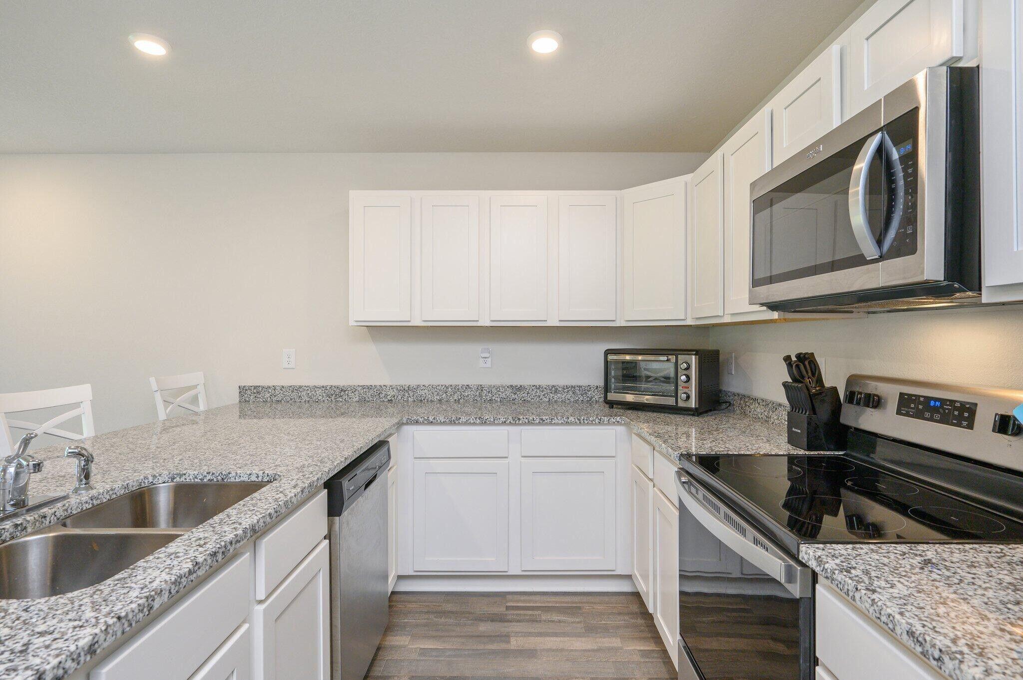 42 Lockwood Way East DeFuniak Springs, FL 32435 - Photo 8 of 39 a kitchen with stainless steel appliances granite countertop a sink stove and microwave