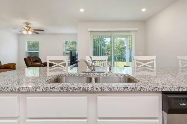 a kitchen with granite countertop a sink and a window