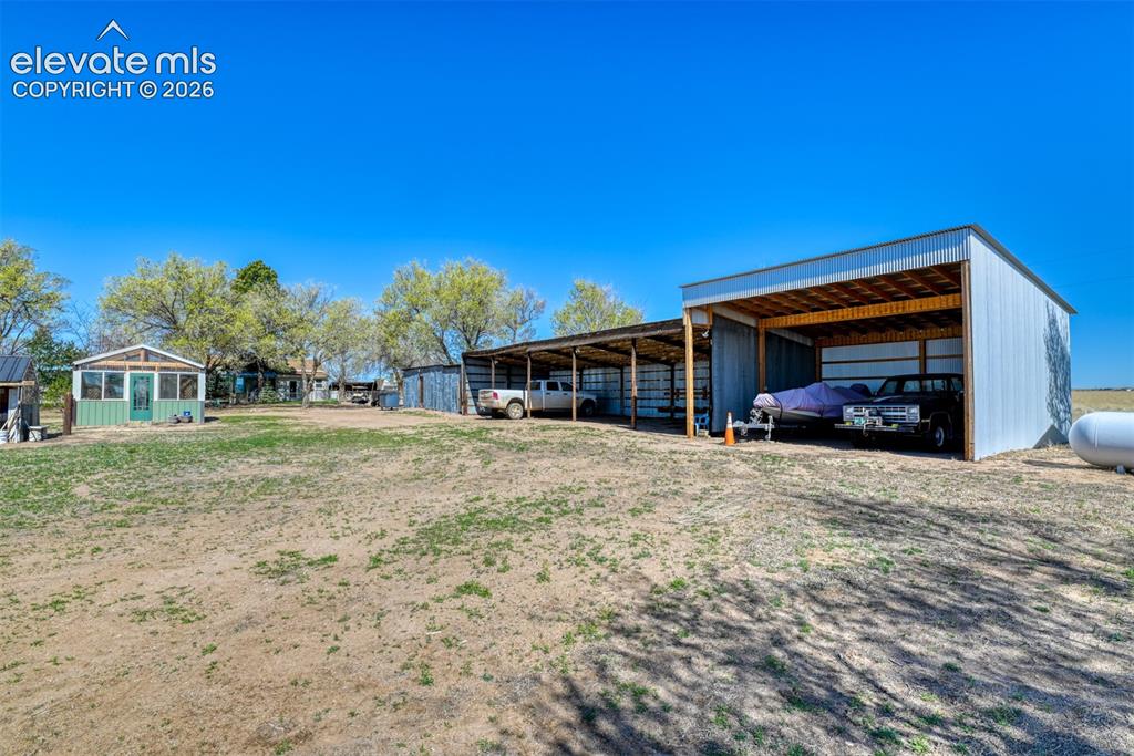 22558 Enoch Road Calhan, CO 80808 - Photo 46 of 50 a front view of a house with a yard and garage