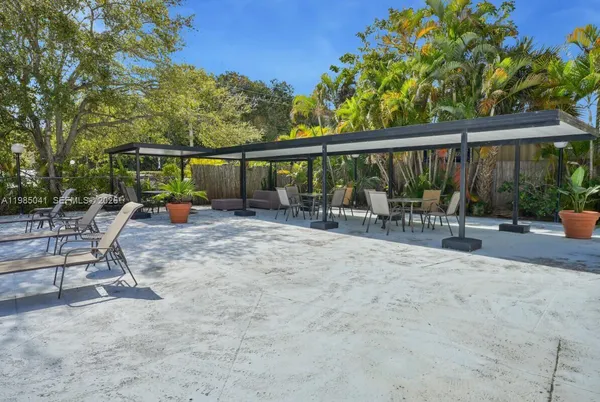 a view of a patio with a table chairs and a backyard