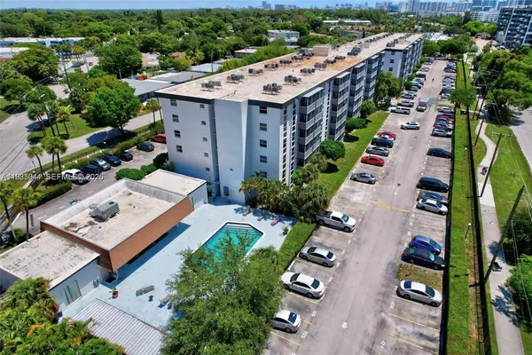 an aerial view of a house with a yard basket ball court and outdoor seating