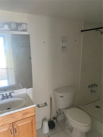 a white toilet sitting next to a bath tub