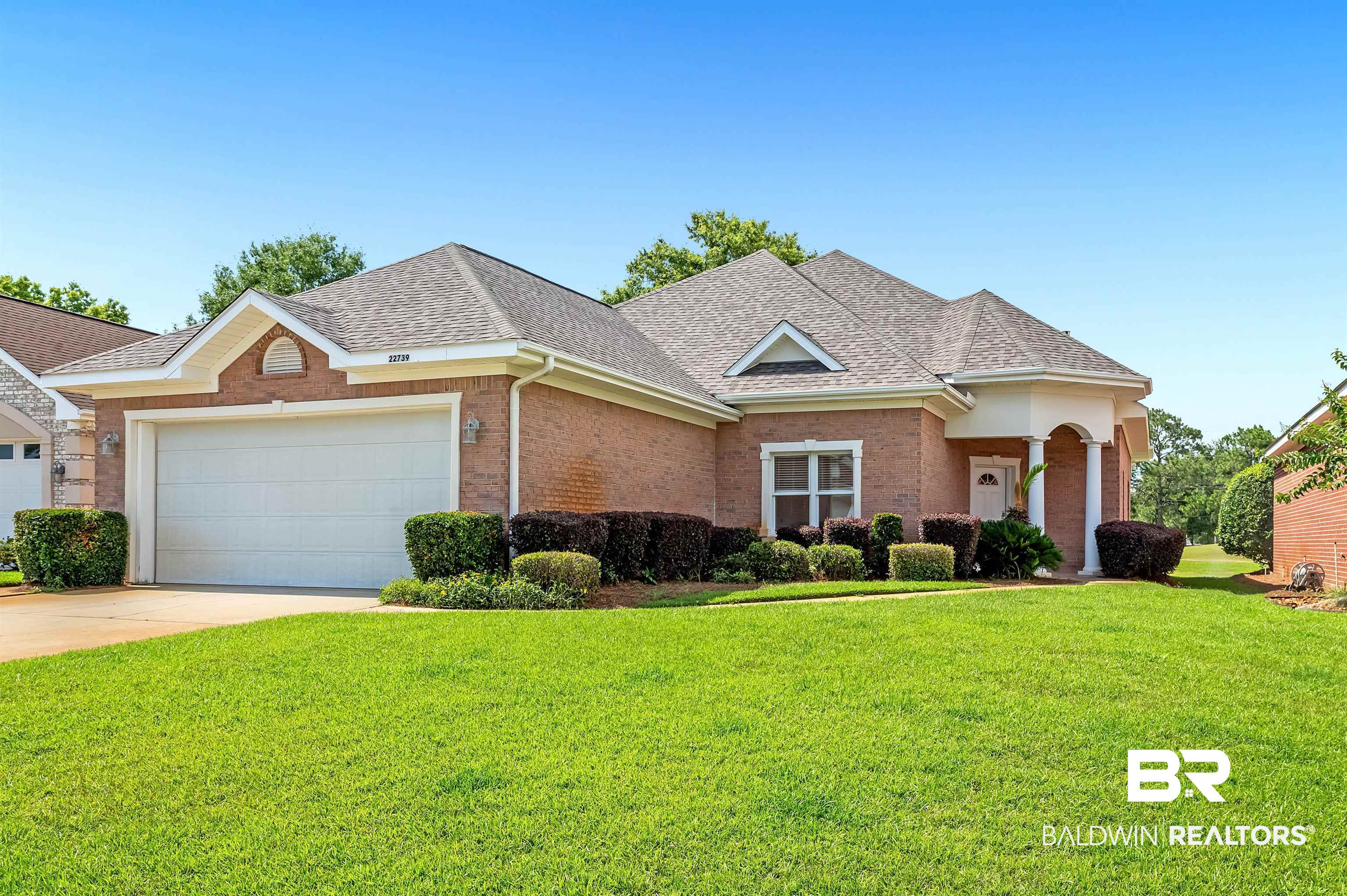 22739 Inverness Way Foley, AL 36535 - Photo 1 of 80 View of front facade with roof with shingles, an attached garage, a front yard, and brick siding