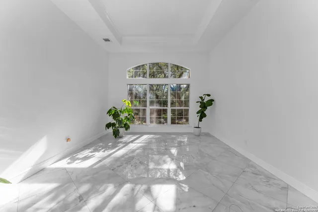 a living room with furniture a chandelier and a fireplace