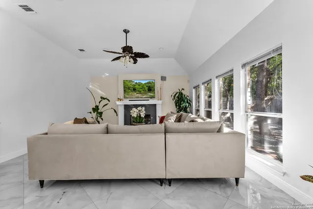 a living room with a fireplace with a potted plant