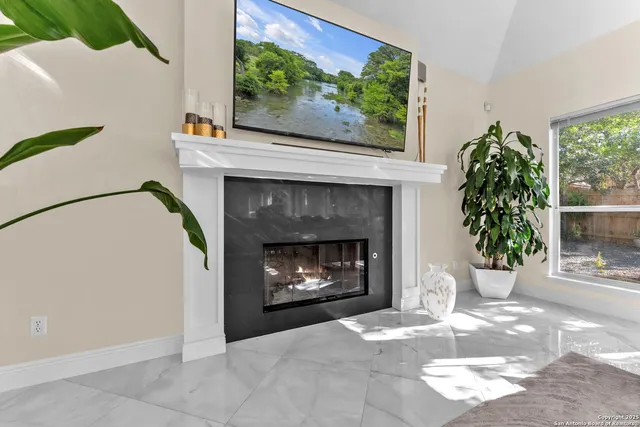 a kitchen with stainless steel appliances granite countertop a sink a refrigerator and a stove