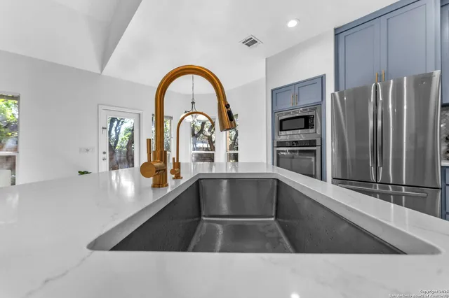 a stove top oven sitting inside of a kitchen