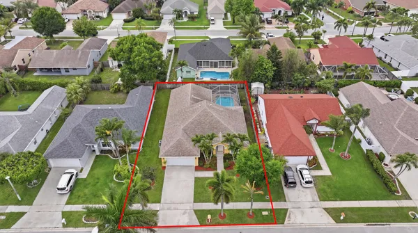 an aerial view of a house with garden space and a street view
