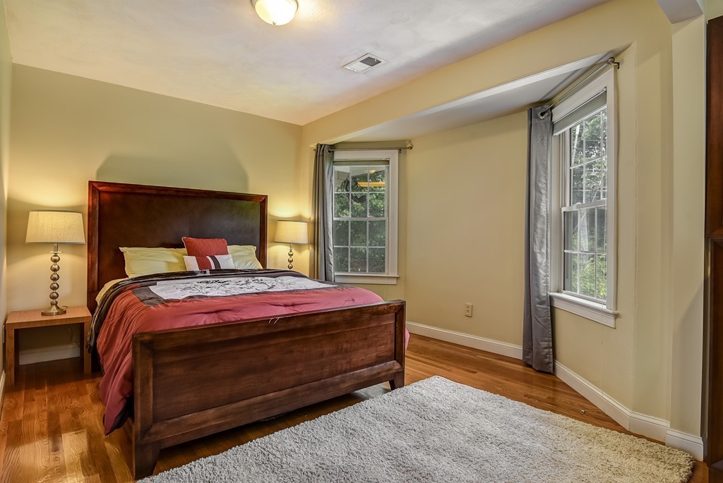 58 Webster Street, Unit 58 Newton, MA 02465 - Photo 18 of 28 a bed sitting in a bedroom next to a window
