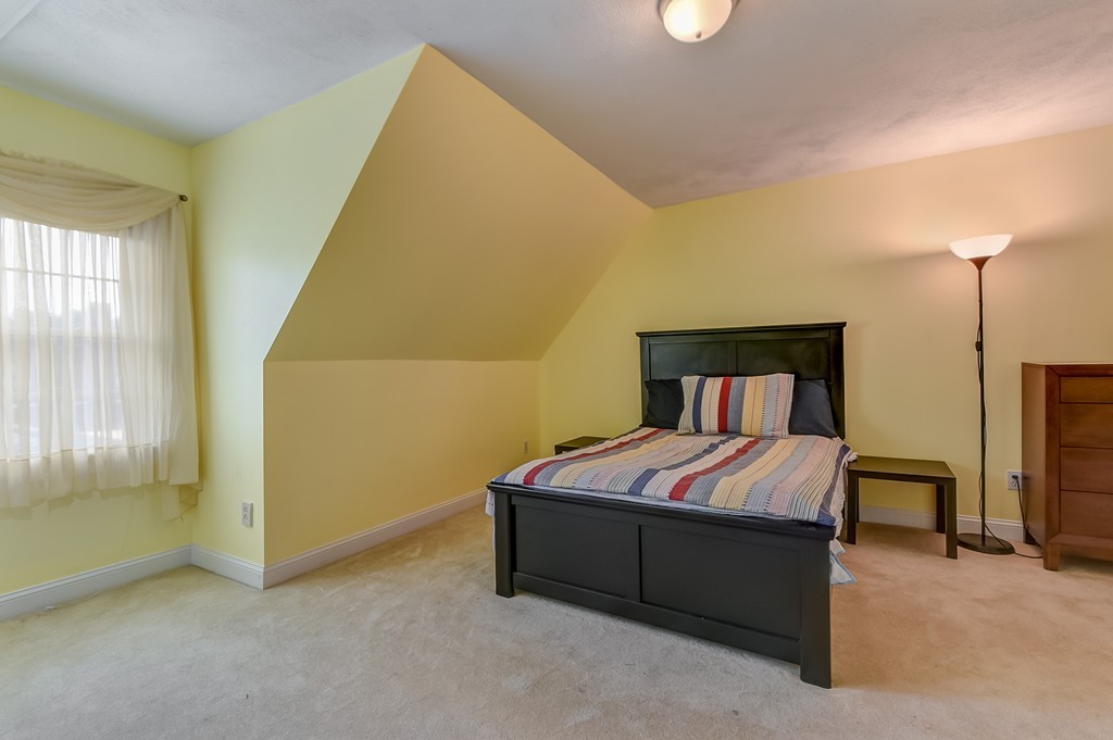 58 Webster Street, Unit 58 Newton, MA 02465 - Photo 19 of 28 a bedroom with a bed and a table