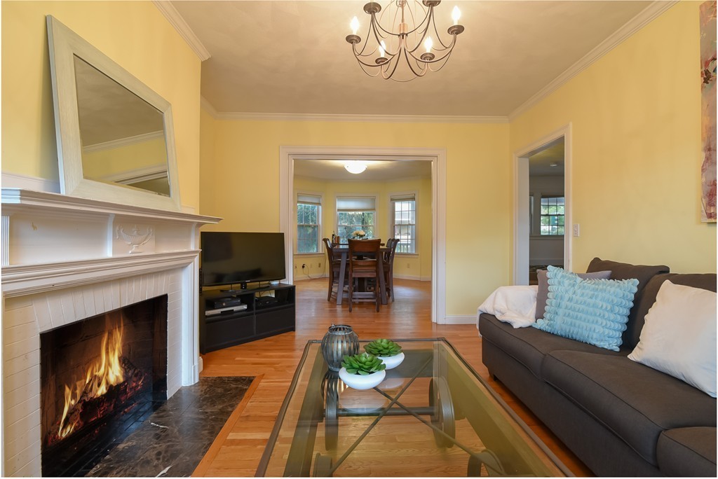 58 Webster Street, Unit 58 Newton, MA 02465 - Photo 9 of 28 a living room with furniture and a fireplace