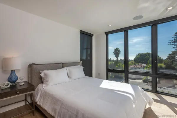 a bedroom with a large bed and a large window