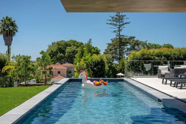 swimming pool view with a sitting space and garden