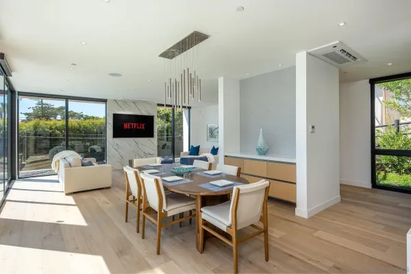 a dining room with furniture and wooden floor