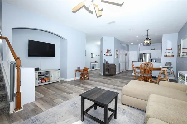 a living room with furniture a flat screen tv and a fireplace