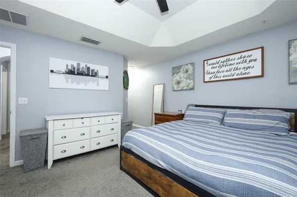 a bedroom with a bed and a dresser