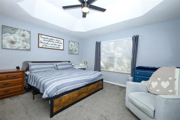 a spacious bedroom with a bed and window