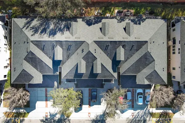 an aerial view of a house with a yard