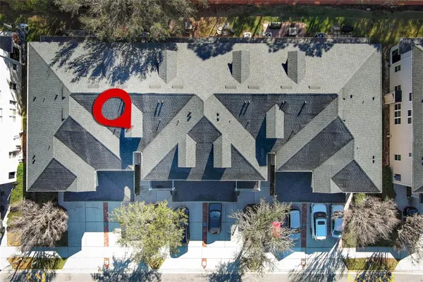 a aerial view of a house with swimming pool and next to a yard