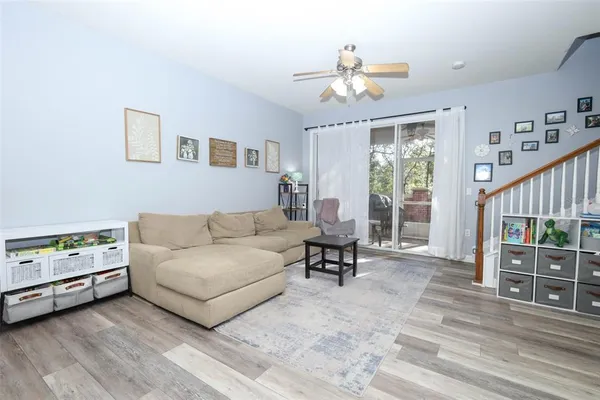 a living room with furniture and wooden floor
