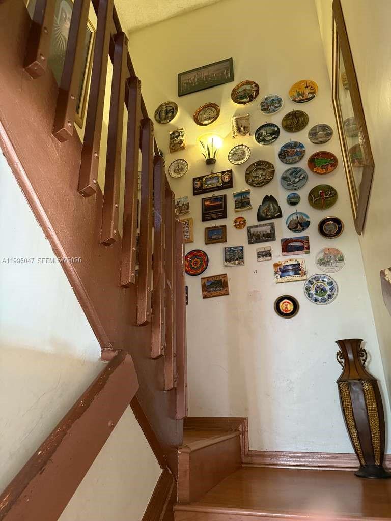 7477 Northwest 167th Street Hialeah, FL 33015 - Photo 13 of 24 a view of walk in closet with clothes and shoes