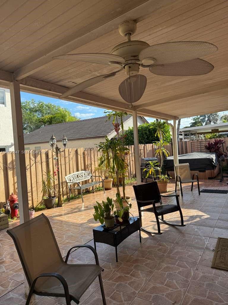 7477 Northwest 167th Street Hialeah, FL 33015 - Photo 21 of 24 a living room with furniture and a large window