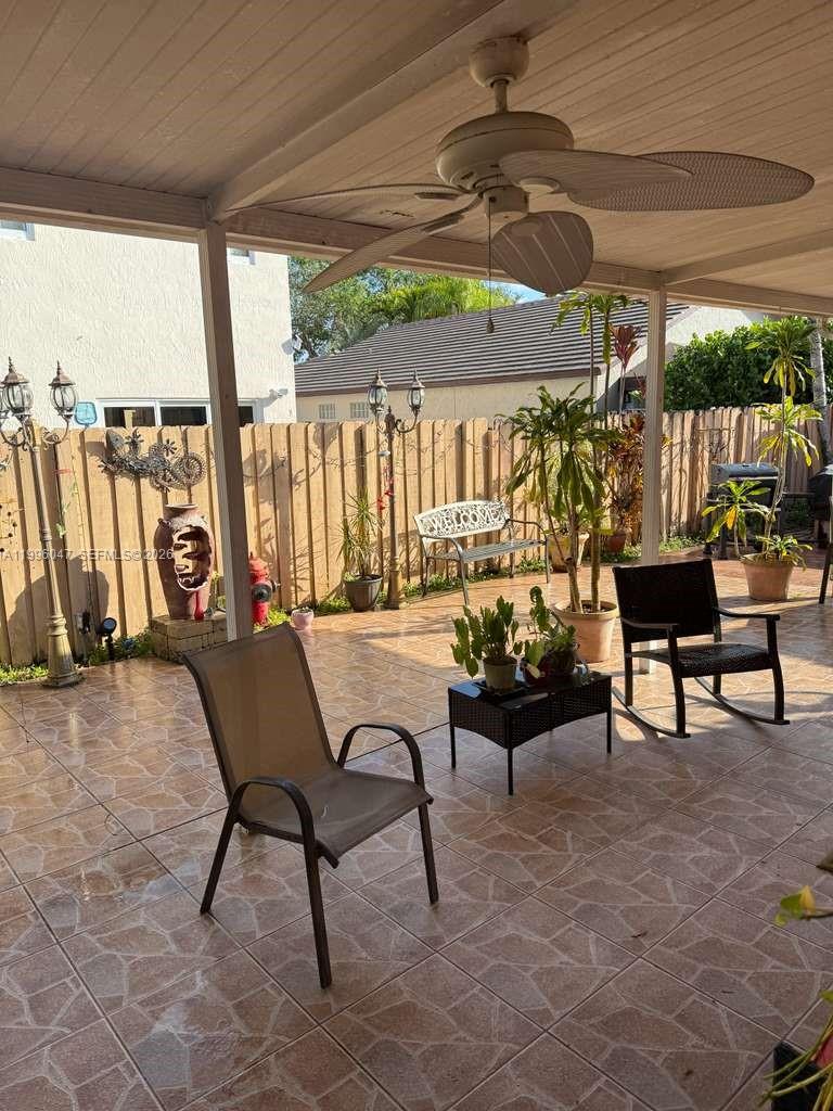 7477 Northwest 167th Street Hialeah, FL 33015 - Photo 23 of 24 a building outdoor space with patio furniture and potted plants