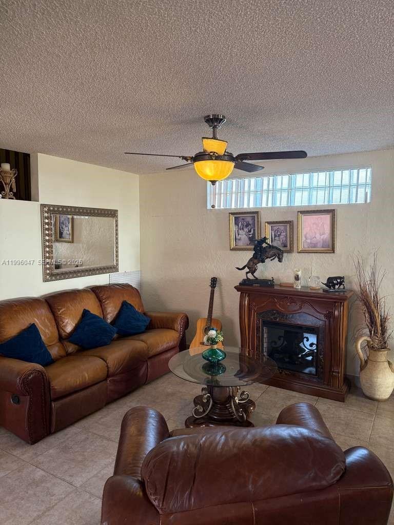 7477 Northwest 167th Street Hialeah, FL 33015 - Photo 5 of 24 a living room with furniture and a fireplace