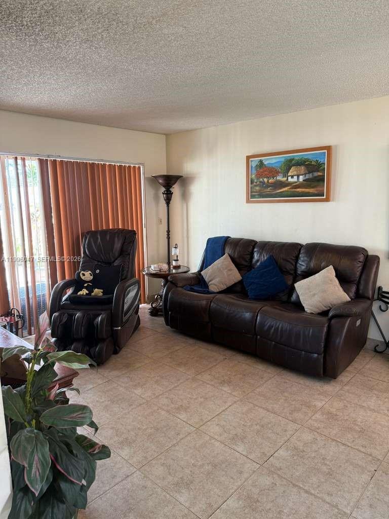 7477 Northwest 167th Street Hialeah, FL 33015 - Photo 6 of 24 a living room with furniture and a window