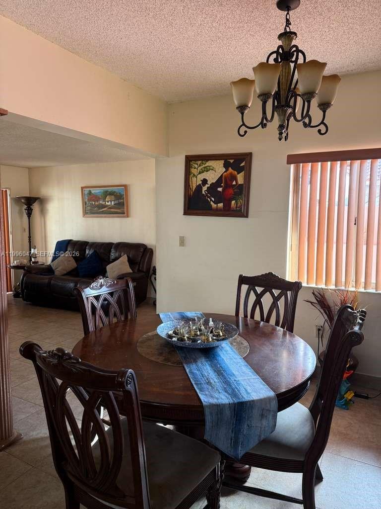 7477 Northwest 167th Street Hialeah, FL 33015 - Photo 7 of 24 a view of a dining room with furniture window and wooden floor