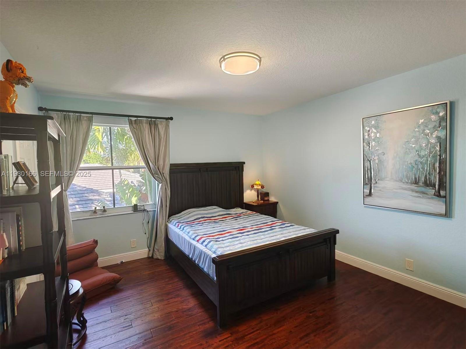 1035 Waterside Circle Weston, FL 33327 - Photo 13 of 40 a room with a bed and a window