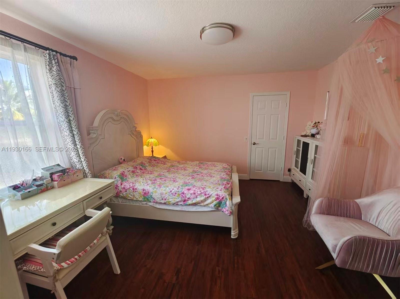 1035 Waterside Circle Weston, FL 33327 - Photo 14 of 40 a bedroom with a bed and wooden floor