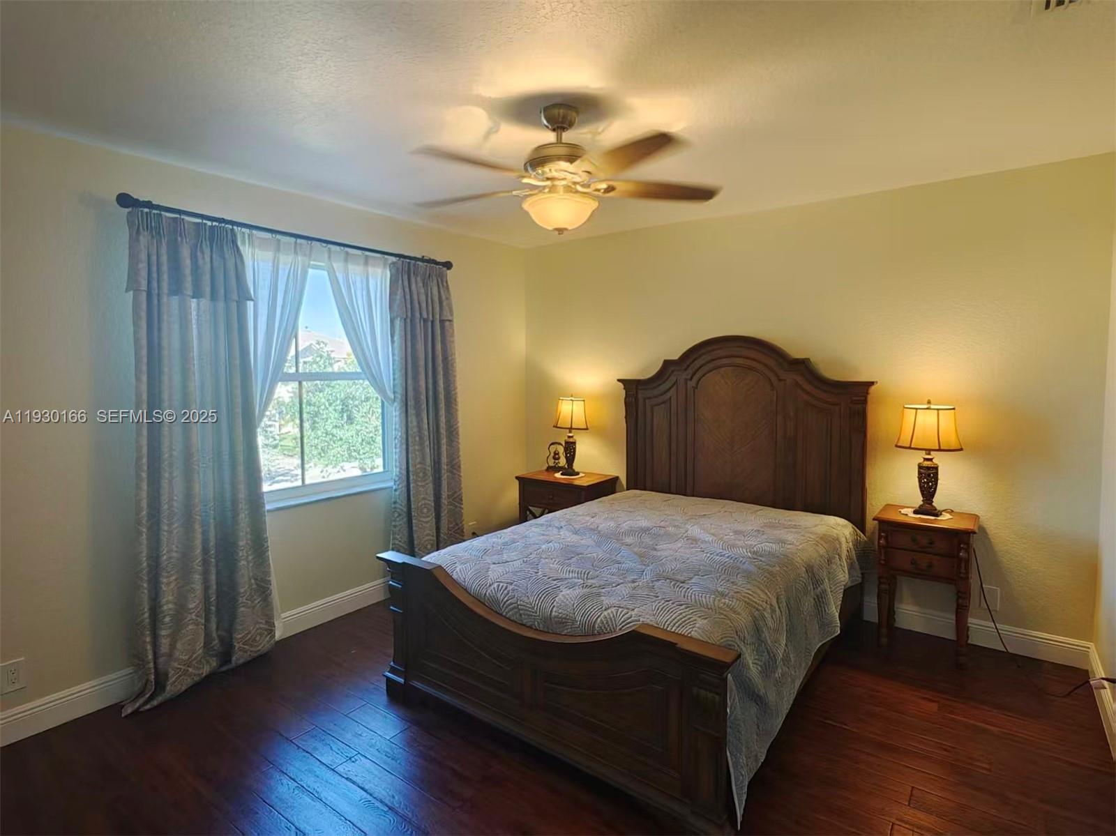 1035 Waterside Circle Weston, FL 33327 - Photo 16 of 40 a bedroom with a bed and a window