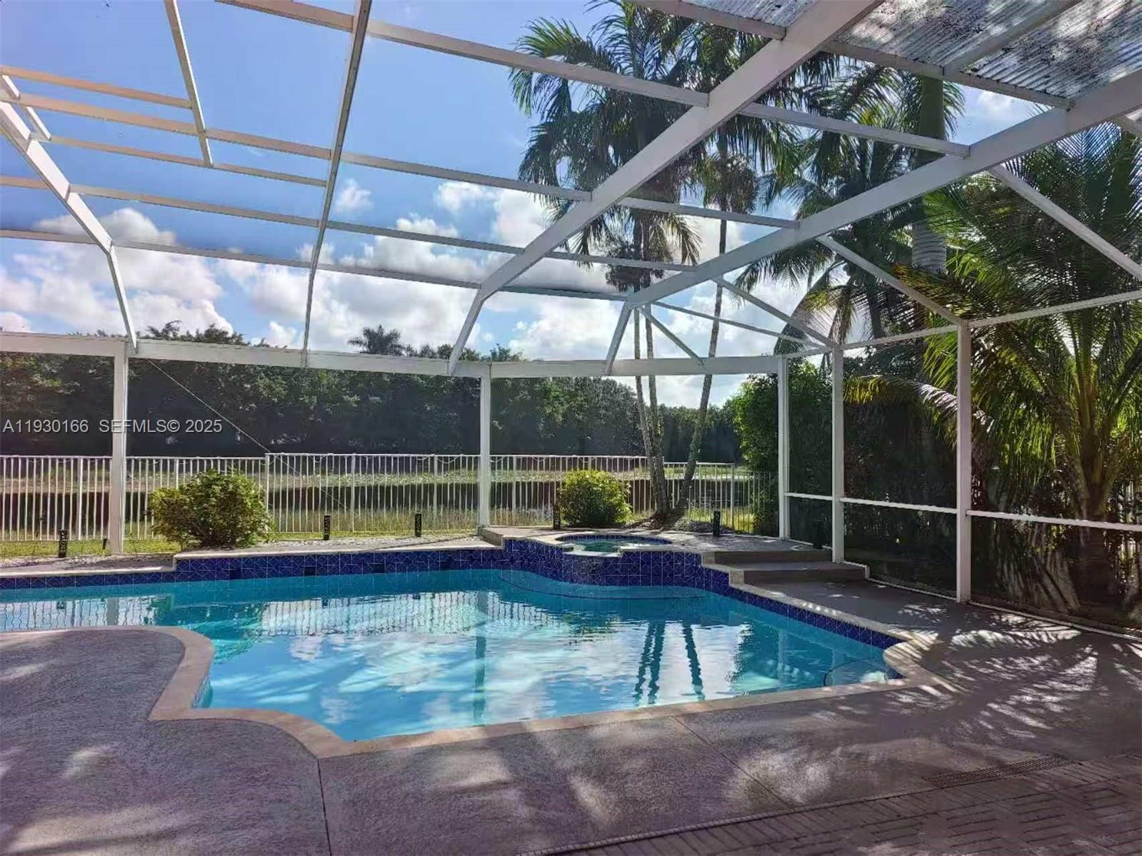 1035 Waterside Circle Weston, FL 33327 - Photo 17 of 40 a view of a backyard with a swimming pool