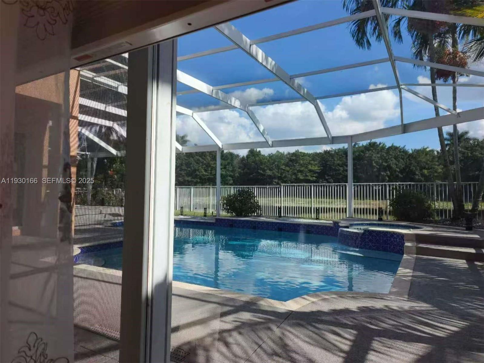 1035 Waterside Circle Weston, FL 33327 - Photo 18 of 40 a view of swimming pool from a room