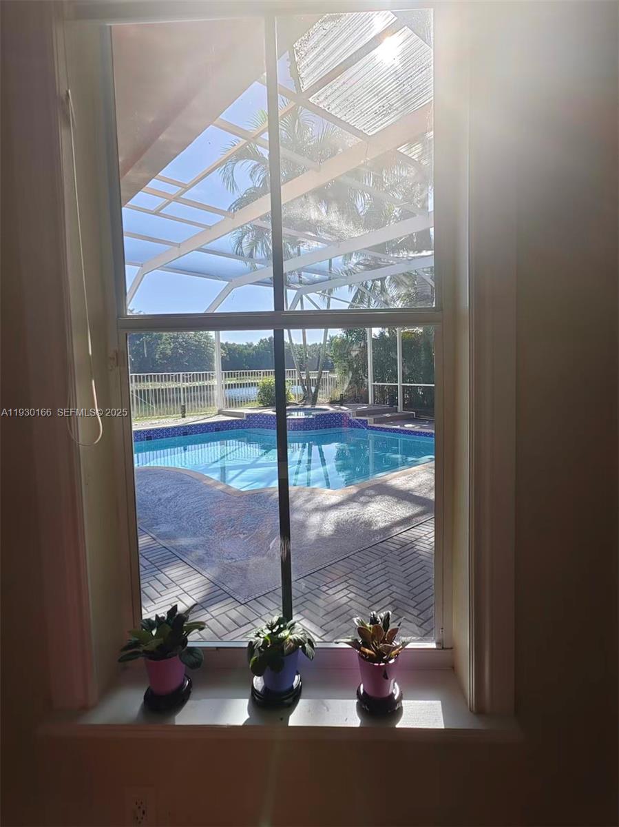 1035 Waterside Circle Weston, FL 33327 - Photo 19 of 40 a view of a room with a floor to ceiling window and an entryway