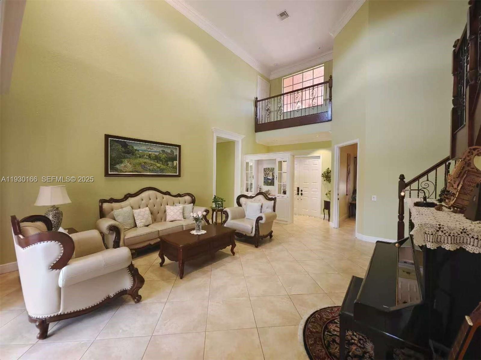 1035 Waterside Circle Weston, FL 33327 - Photo 2 of 40 a living room with furniture and a flat screen tv