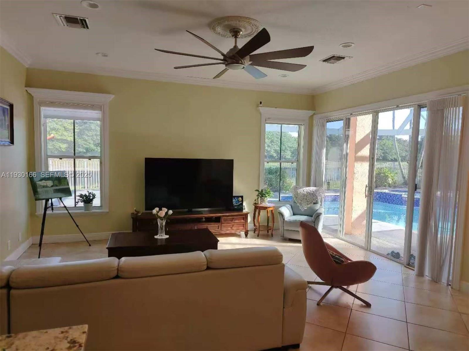 1035 Waterside Circle Weston, FL 33327 - Photo 21 of 40 a living room with furniture and a flat screen tv