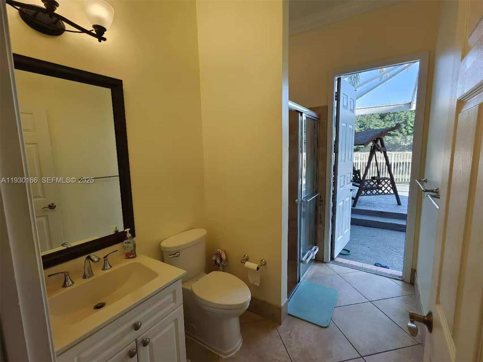 1035 Waterside Circle Weston, FL 33327 - Photo 22 of 40 a bathroom with a granite countertop sink toilet and shower