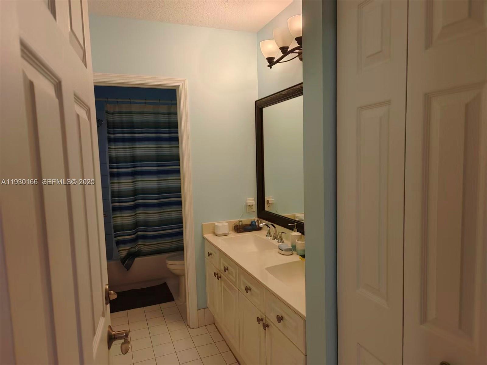 1035 Waterside Circle Weston, FL 33327 - Photo 23 of 40 a bathroom with a sink and a mirror
