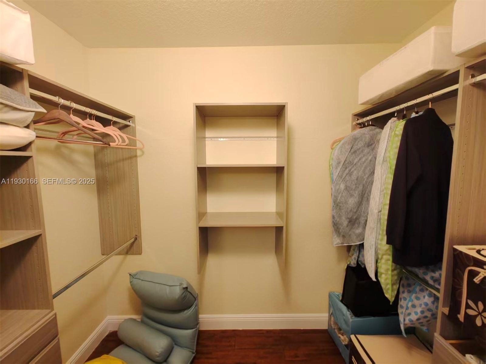 1035 Waterside Circle Weston, FL 33327 - Photo 25 of 40 a view of walk in closet with clothes and shoes