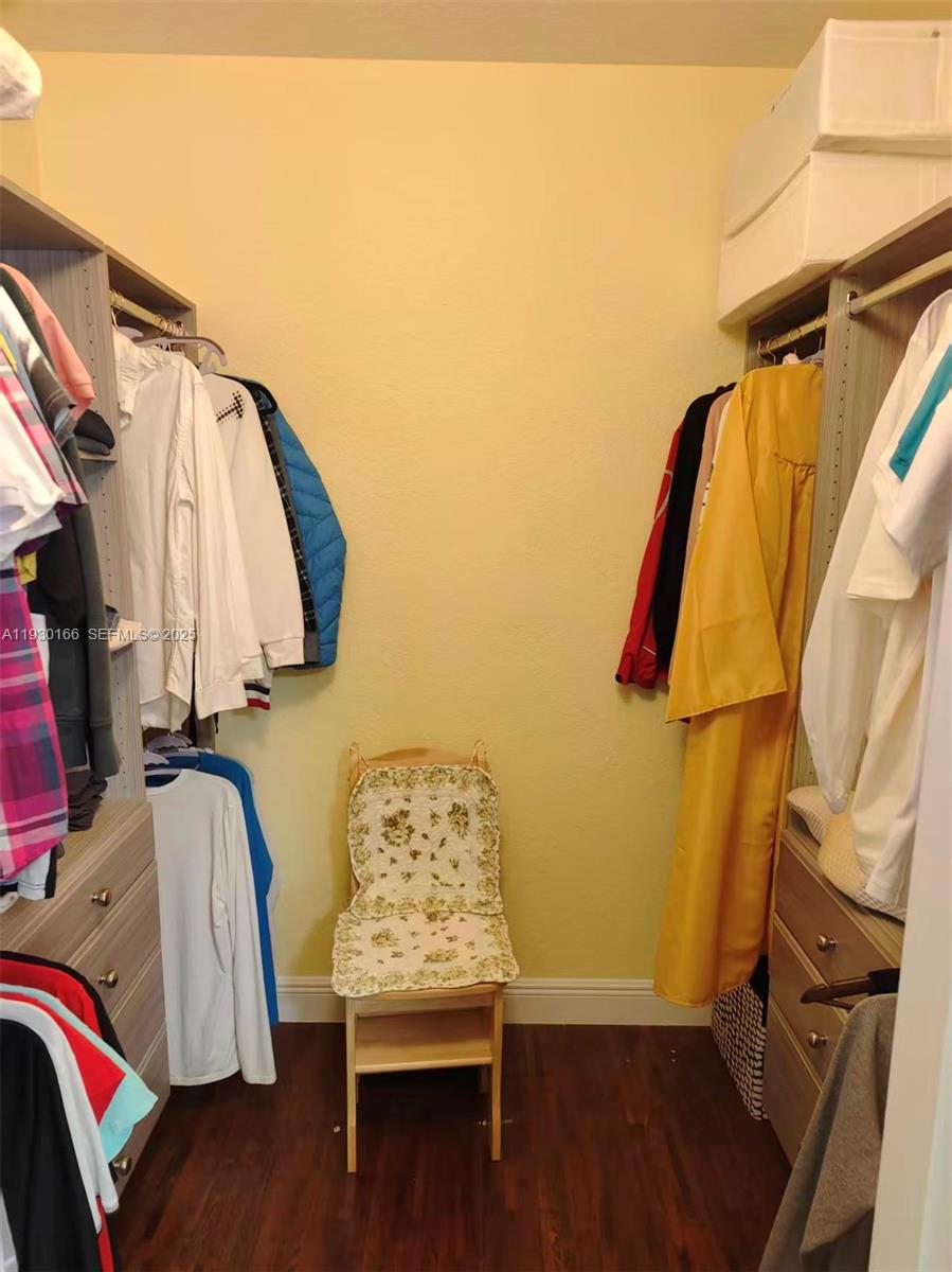 1035 Waterside Circle Weston, FL 33327 - Photo 29 of 40 a view of walk in closet with clothes and shoes