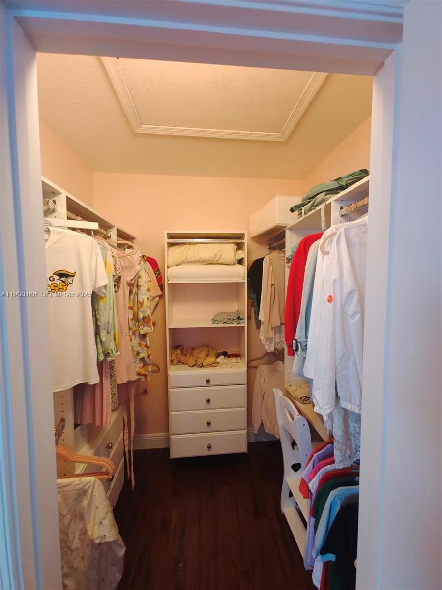 1035 Waterside Circle Weston, FL 33327 - Photo 31 of 40 a view of walk in closet with clothes and shoes