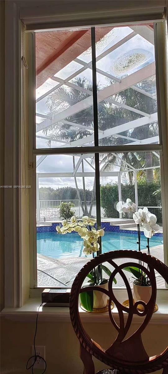 1035 Waterside Circle Weston, FL 33327 - Photo 35 of 40 a room with wooden floor and a window