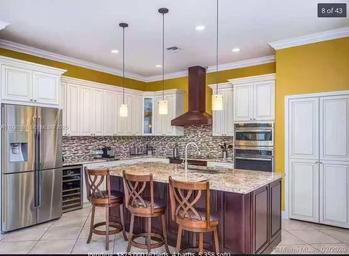 1035 Waterside Circle Weston, FL 33327 - Photo 5 of 40 a kitchen with a table and chairs in it